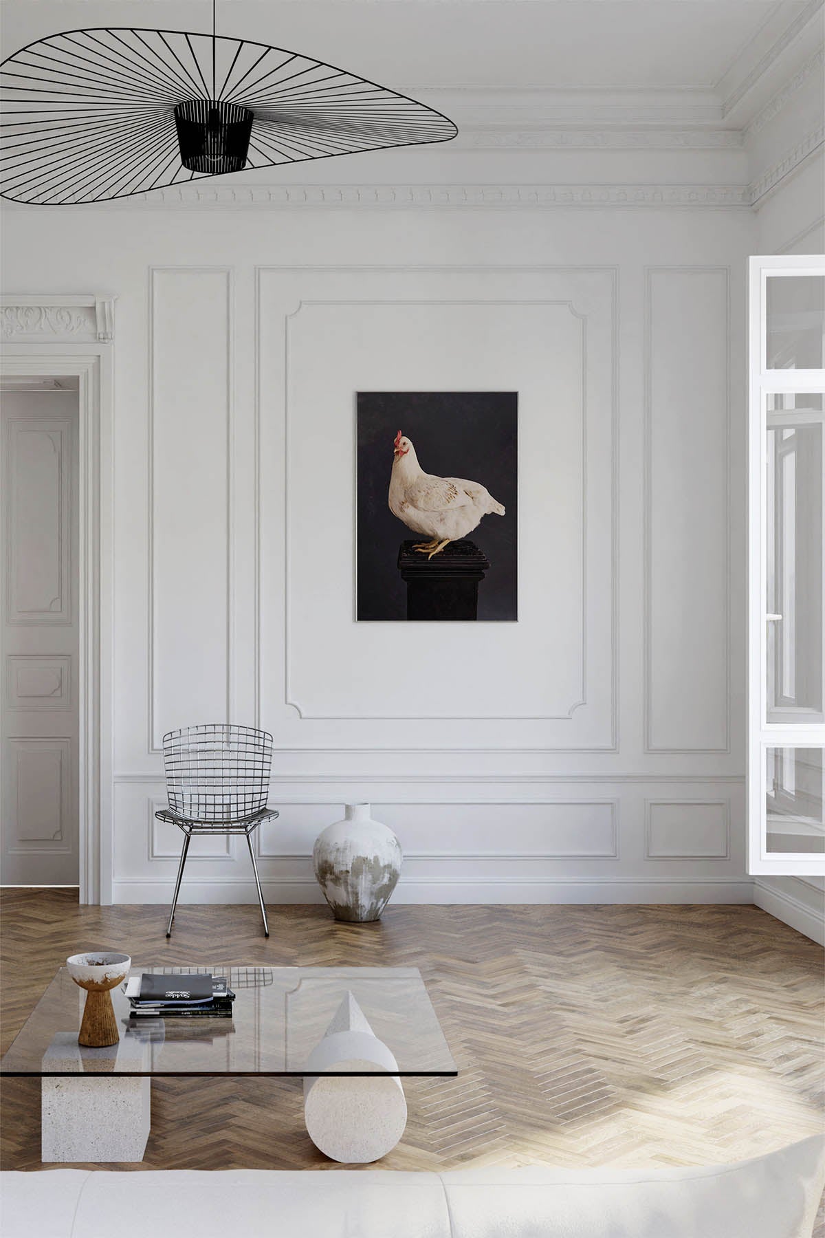 Fine Art Print Of A White Chicken Standing On A Black Plinth With A Black Background Framed On A Wall In An European Style Entry Way or Living Room Near A Harry Bertoia Mid Century Wire Chair and open window.