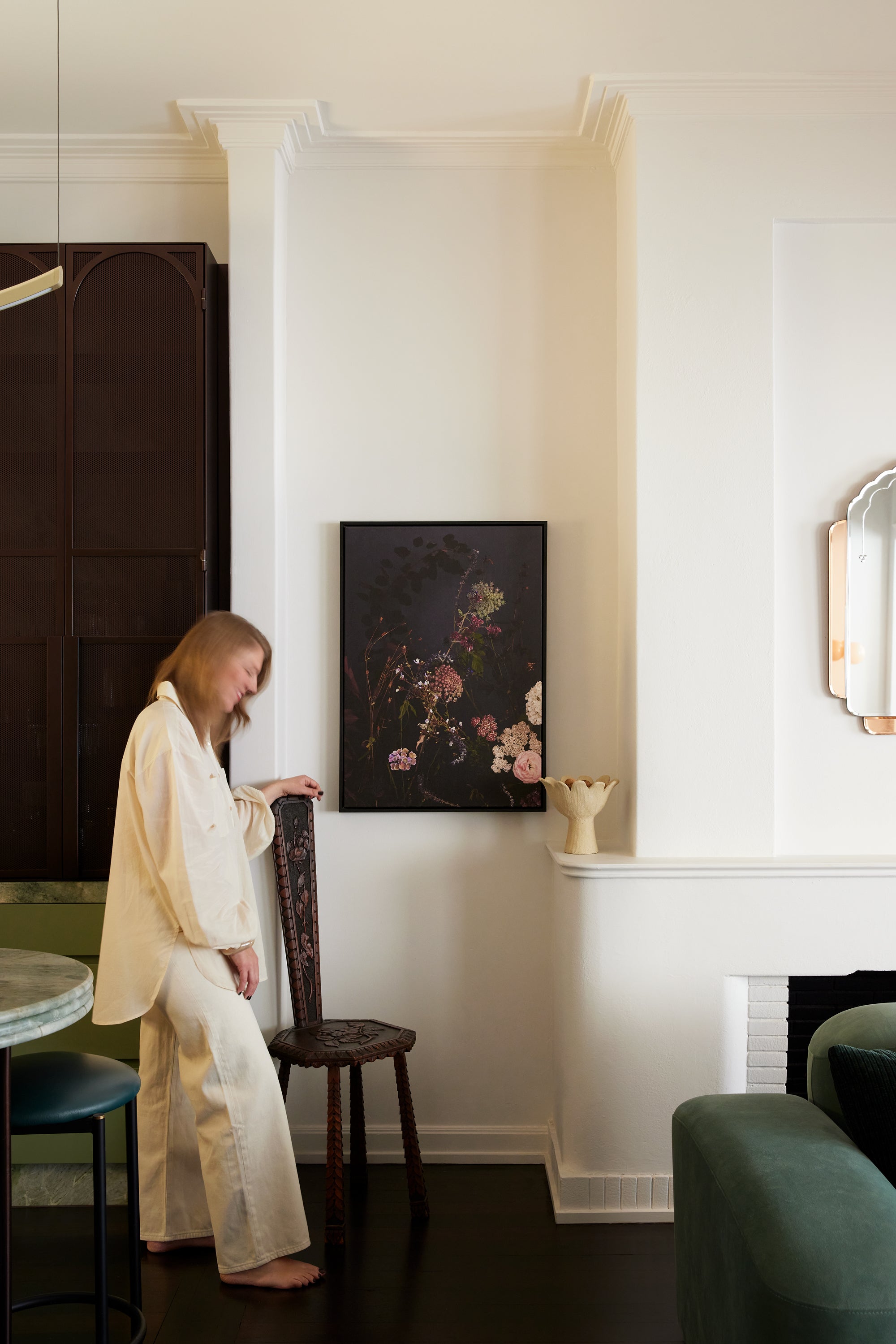 Fine art print of romantic pink and white hydrangeas on a dark moody background displayed in an elegant cream dining room with architectural molding