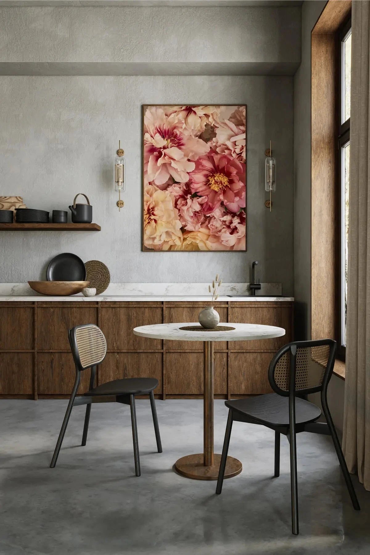Fine art print of layered pink and cream peonies displayed above a marble dining table in a contemporary kitchen with sage green walls